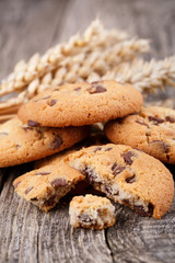 Tasty cookies with wheat on a wooden table.
