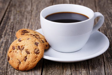 Cup of coffee with cookies on a wooden table. - Powered by Adobe