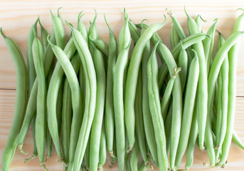 Green beans on wooden background
