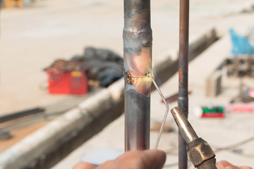 Plumbing contractor works sweating