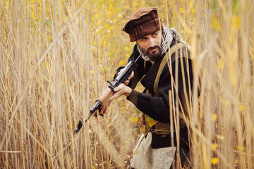 Fototapeta premium Portrait of serious middle eastern man with rifle