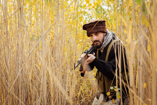 Portrait of serious middle eastern man with rifle