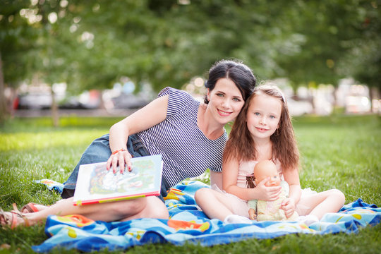 Mom and daughter reading a book