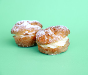 cream puff with filling and powdered sugar topping