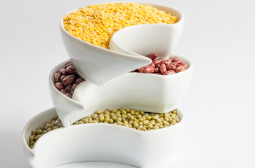 Multicolored beans in white ceramics bowl