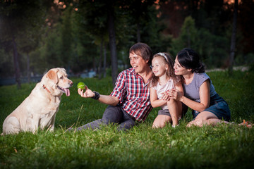 Fototapeta premium family pllaying with dog