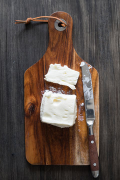 Creamy Italian Stracchino Cheese on the Wooden Cutting Board