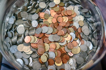Thai coins in glass bucket
