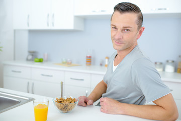 Bachelor eating breakfast alone