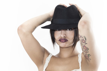 Beautiful woman grouching and wearing black hat