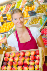 Woman holding a crate of fruit