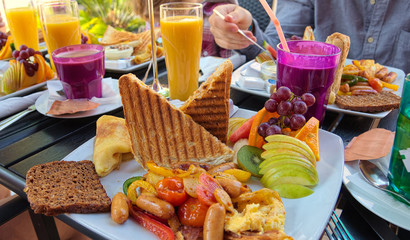 Colorfully covered brunch table at an outdoor cafe