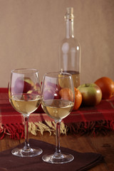 Wineglasses, bottle and fruits