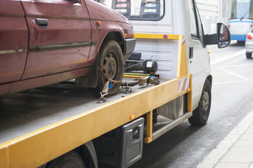 Roadside assistance car towing truck in the city
