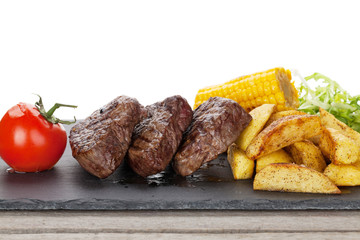 Steak with grilled potato, corn, salad and tomato