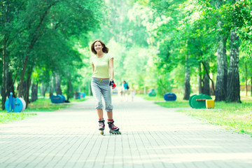 Roller skating sporty girl in park rollerblading on inline skate