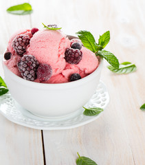 Pink ice cream with leaves of mint and berries