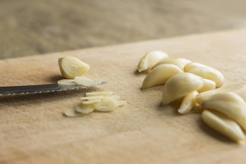 Fototapeta na wymiar Slicing Fresh Pealed Garlic Cloves