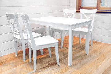 Fototapeta premium Wooden white dining table and four chairs