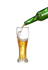 Isolated Beer is poured into a glass from bottle
