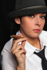 the girl keeps in fingers a cigar