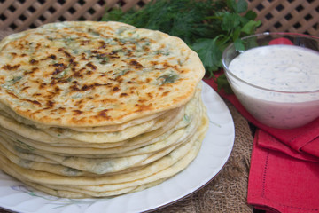  Thin pie with herbs and cheese. selective focus