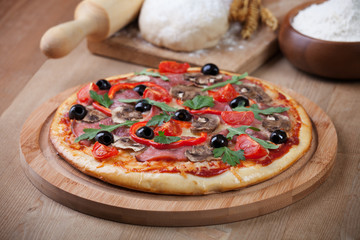 fresh pizza and ingredients on board