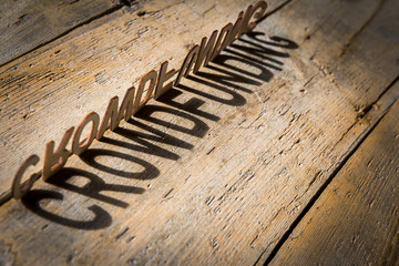 Wooden letters build the word crowdfunding