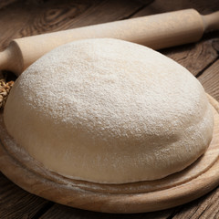 Dough on the old board. Dramatic light