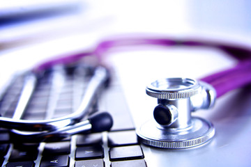 Violet stethoscope on a laptop computer