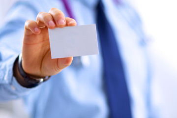 Male doctor holding empty white card