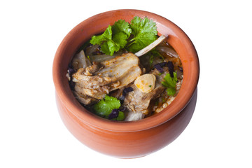 ribs soup, cilantro, basil in a pot crock