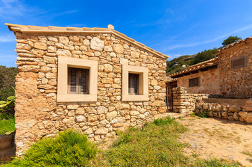 Fototapeta na wymiar Stone houses in Cala S'Almunia bay, Majorca island, Spain