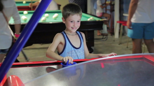 child playing air hockey, joy and emotion, 1080p HD video