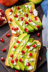 Avocado sandwich with feta and pomegranate