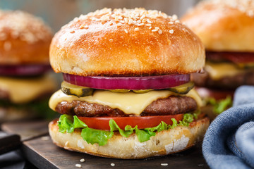 Delicious burger on wooden board