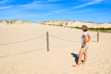 Young woman tourist on dune in Slowinski National Park, Poland