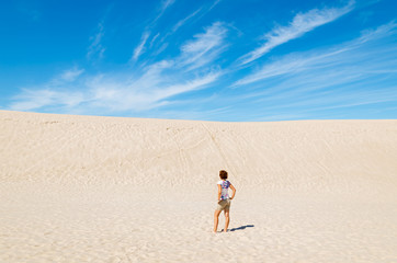 Fototapeta na wymiar Young woman tourist on dune in Slowinski National Park, Poland
