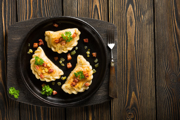 Fried dumplings with onion and bacon top view
