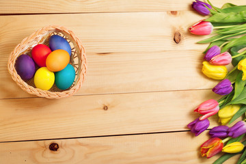 Spring Flowers bunch and easter eggs at wood floor texture. Beau