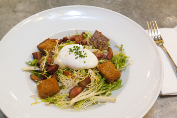 Frisee Salad with Lardon, Poached Egg and Croutons
