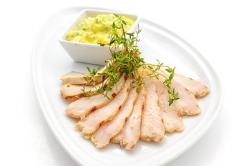 Sliced ham with yellow sauce studio shot