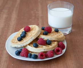 Breakfast.  Waffles with berries and milk