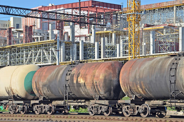 Fototapeta na wymiar Railroad tank wagon and construction site background