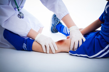 Soccer player's knee with a bruise. Studio shot