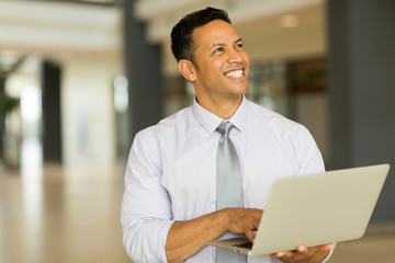 Fototapeta na wymiar mature business man holding laptop computer