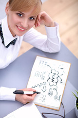 Portrait of  businesswoman sitting at  desk with a laptop