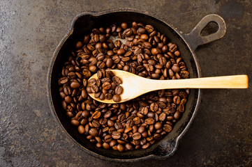 Spoon roasting coffee beans in a pan