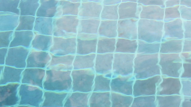 Background of rippled pattern of clean water in blue swimming pool