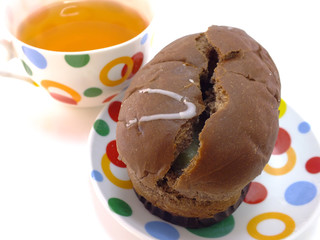 tea and chocolate bread on red tablecloth